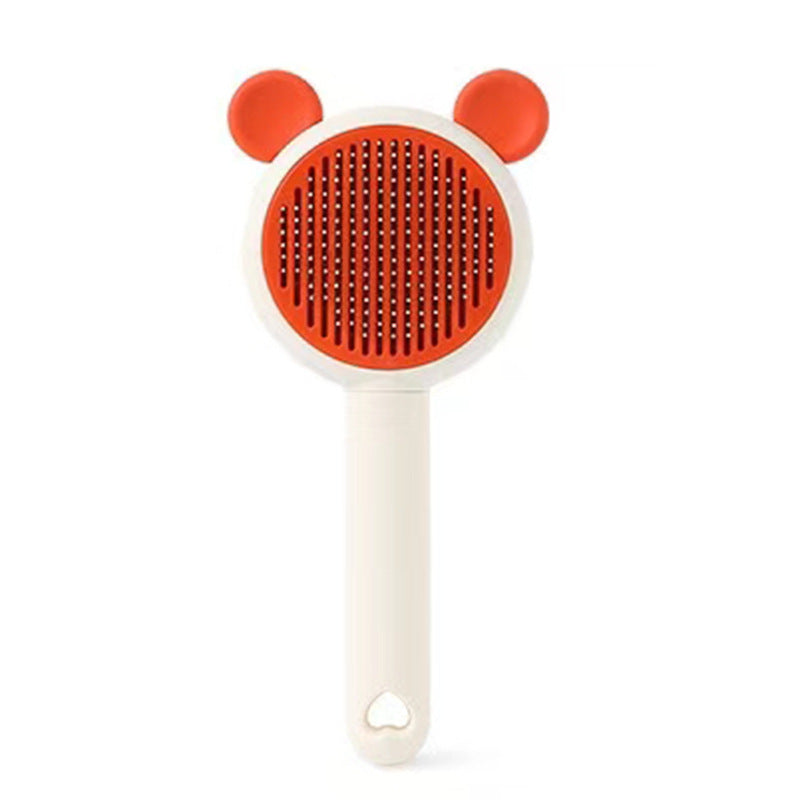 Orange bear-style self-cleaning pet grooming brush variant.
