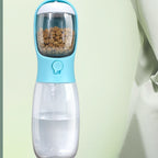 Sky blue pet water and food bottle with food container nested in the drinking trough and clear water reservoir.