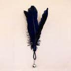 Large black fluffy feather head variant with bell attachment.