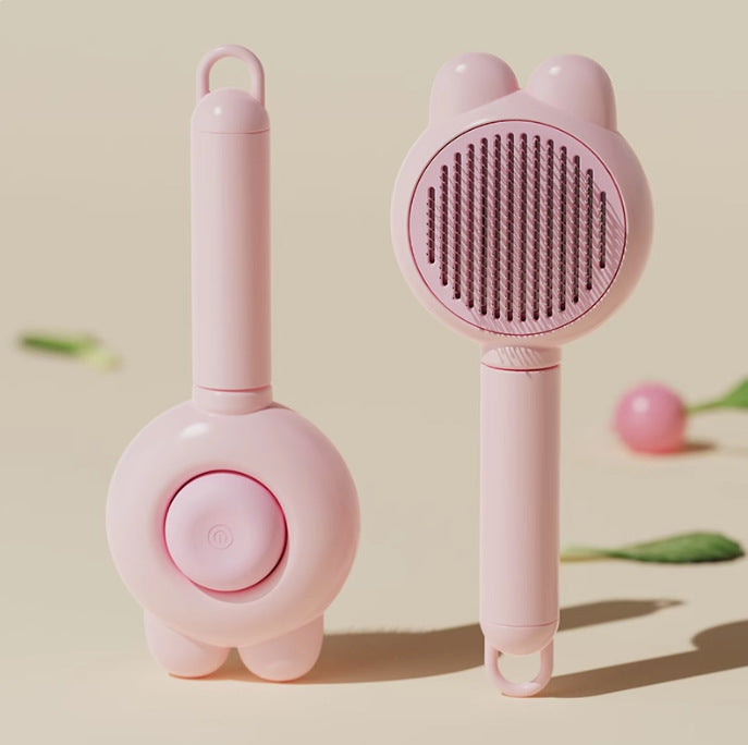 Peach pink pet massage and deshedding comb variant.