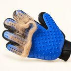 Close detail of loose pet hair collected across the blue silicone bristles of the grooming glove.