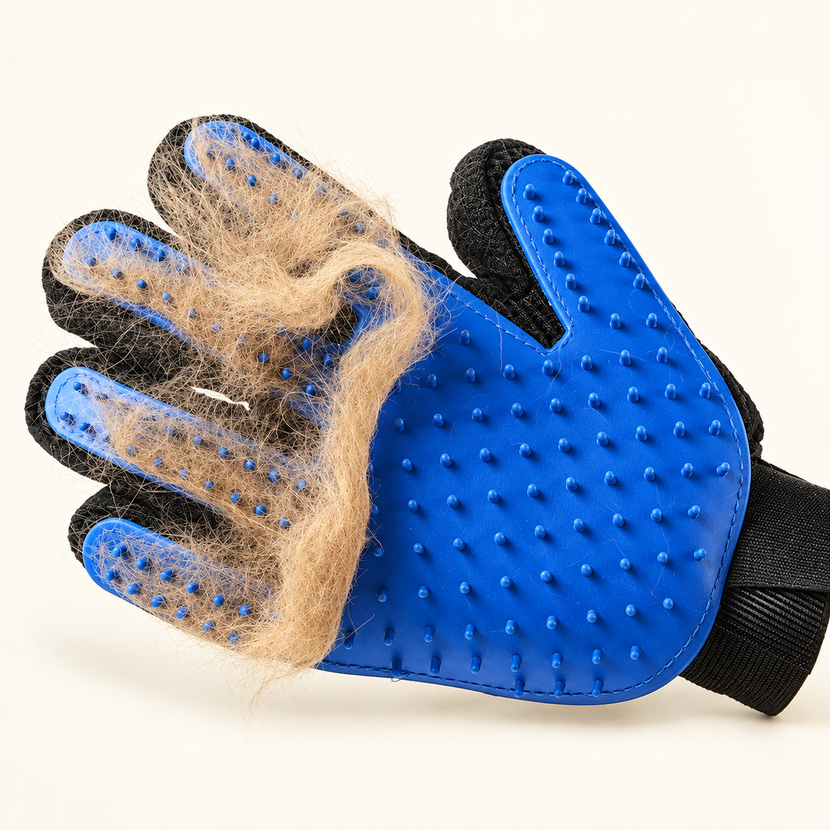 Close detail of loose pet hair collected across the blue silicone bristles of the grooming glove.