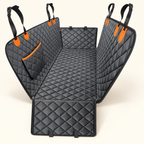 Black diamond-quilted dog car seat hammock mat with orange attachment accents on a warm ivory background.