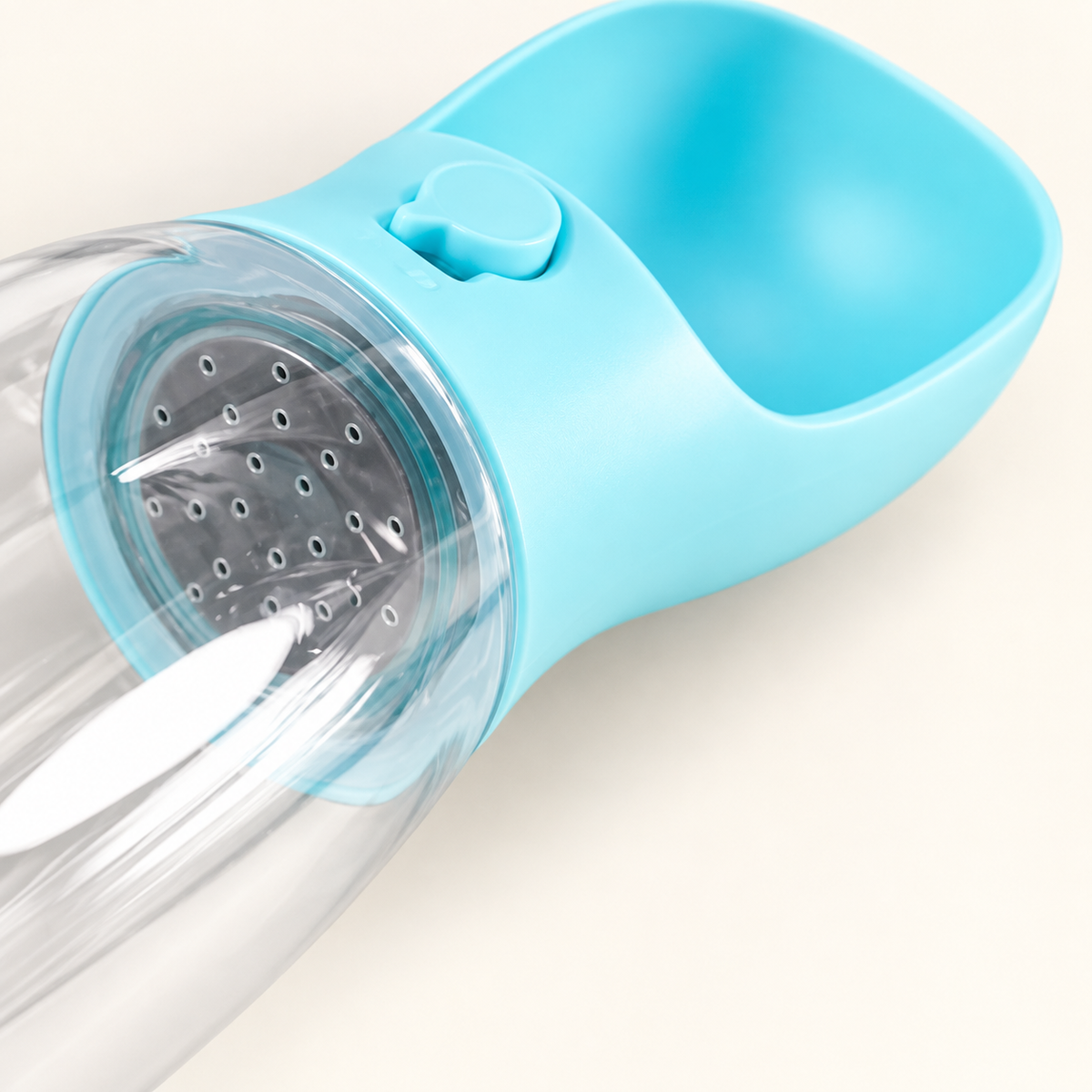 Close-up of the sky blue bottle's drinking trough, control slider and perforated insert visible through the clear reservoir.